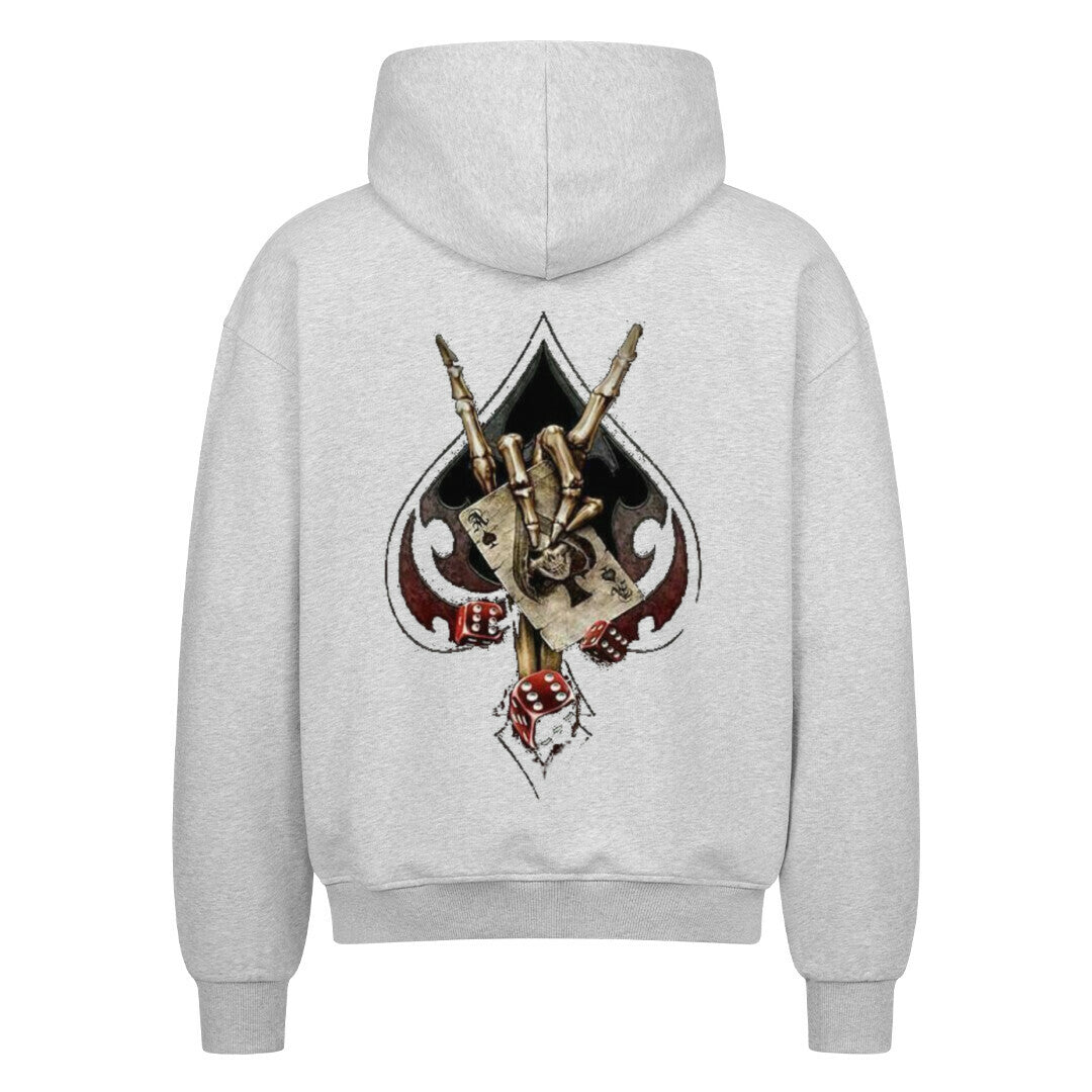 Back view of a heather grey hoodie featuring a bold biker-themed backprint with a skeletal hand throwing the horns, playing cards, dice, and spade symbol – worn by rebellious streetwear fans.
