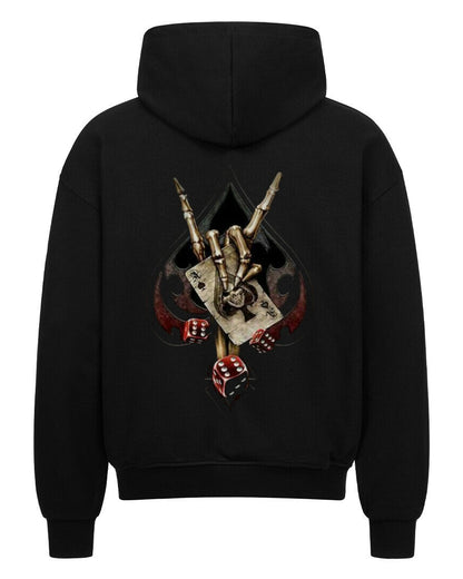 Back view of a black hoodie featuring a bold biker-themed backprint with a skeletal hand throwing the horns, playing cards, dice, and spade symbol – worn by rebellious streetwear fans.
